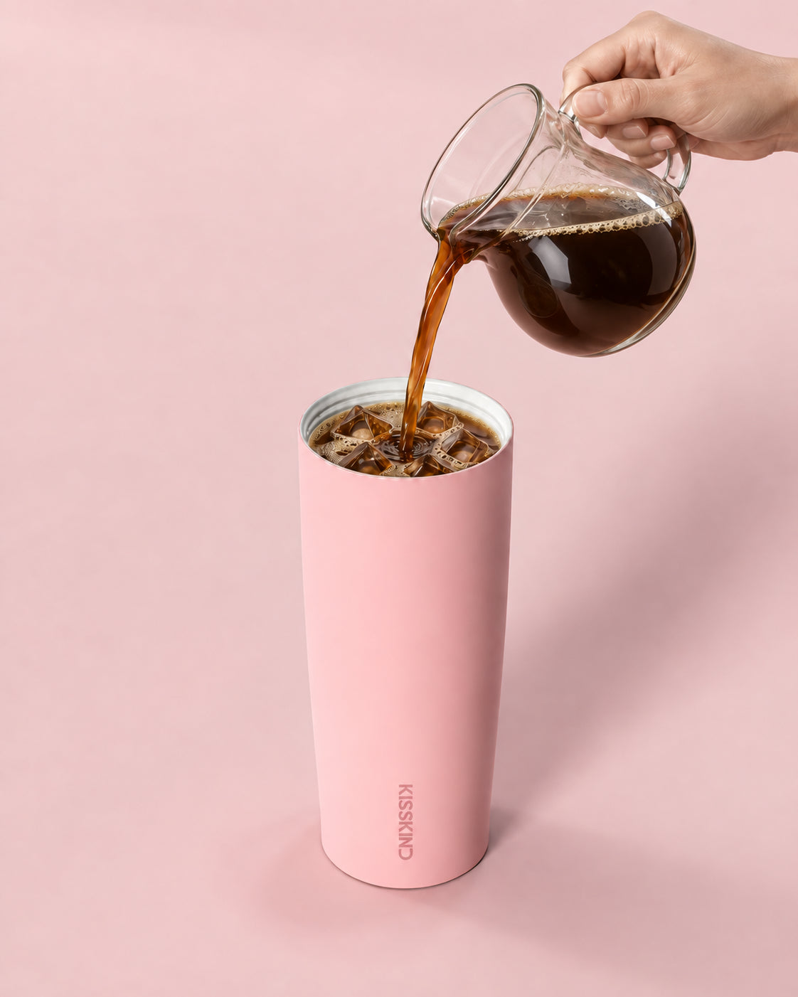 Iced coffee poured into the cup, white ceramic lining visible