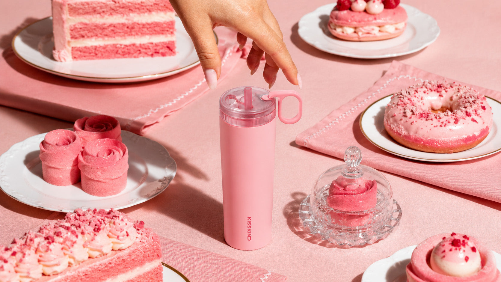 Pink Kisskind insulated cup surrounded by pink desserts