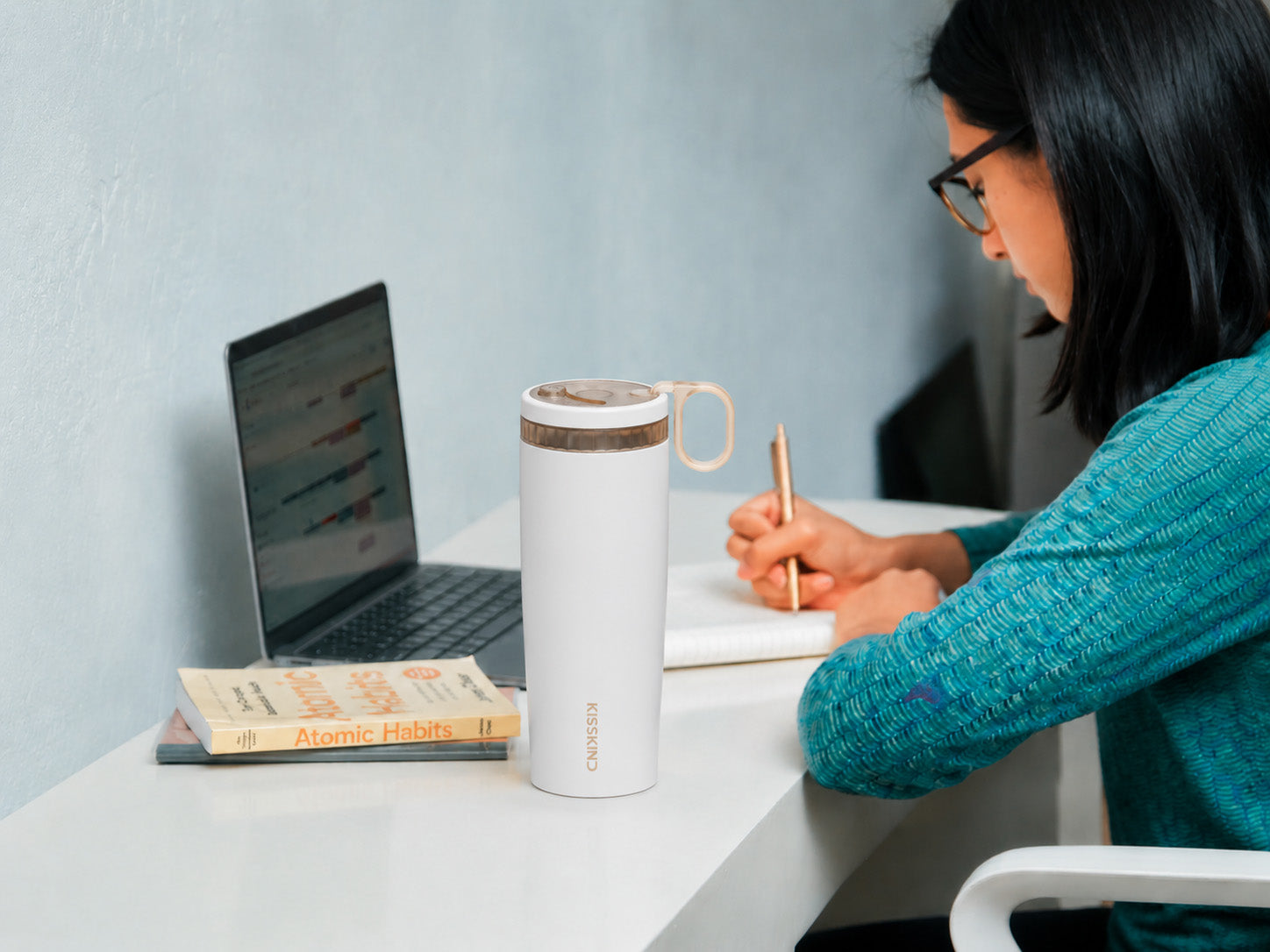 KissKind iced coffee cup at a work desk