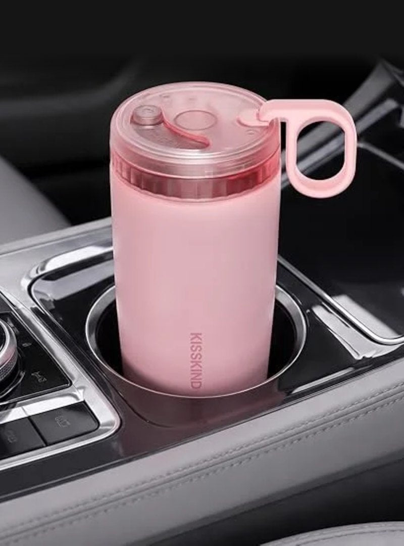 Pink cup sitting in a car cup holder