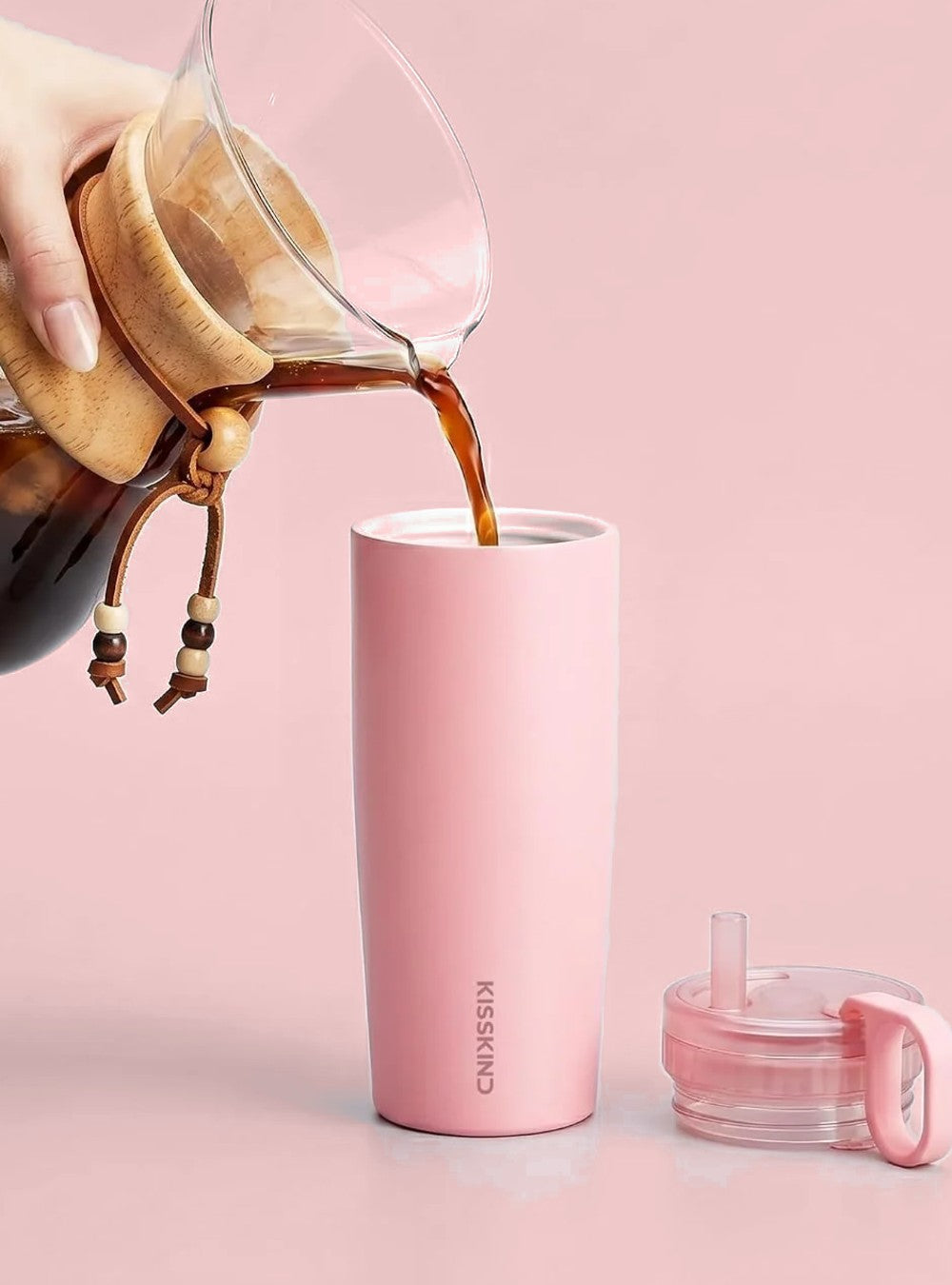 Coffee poured into the pink cup, white ceramic interior visible