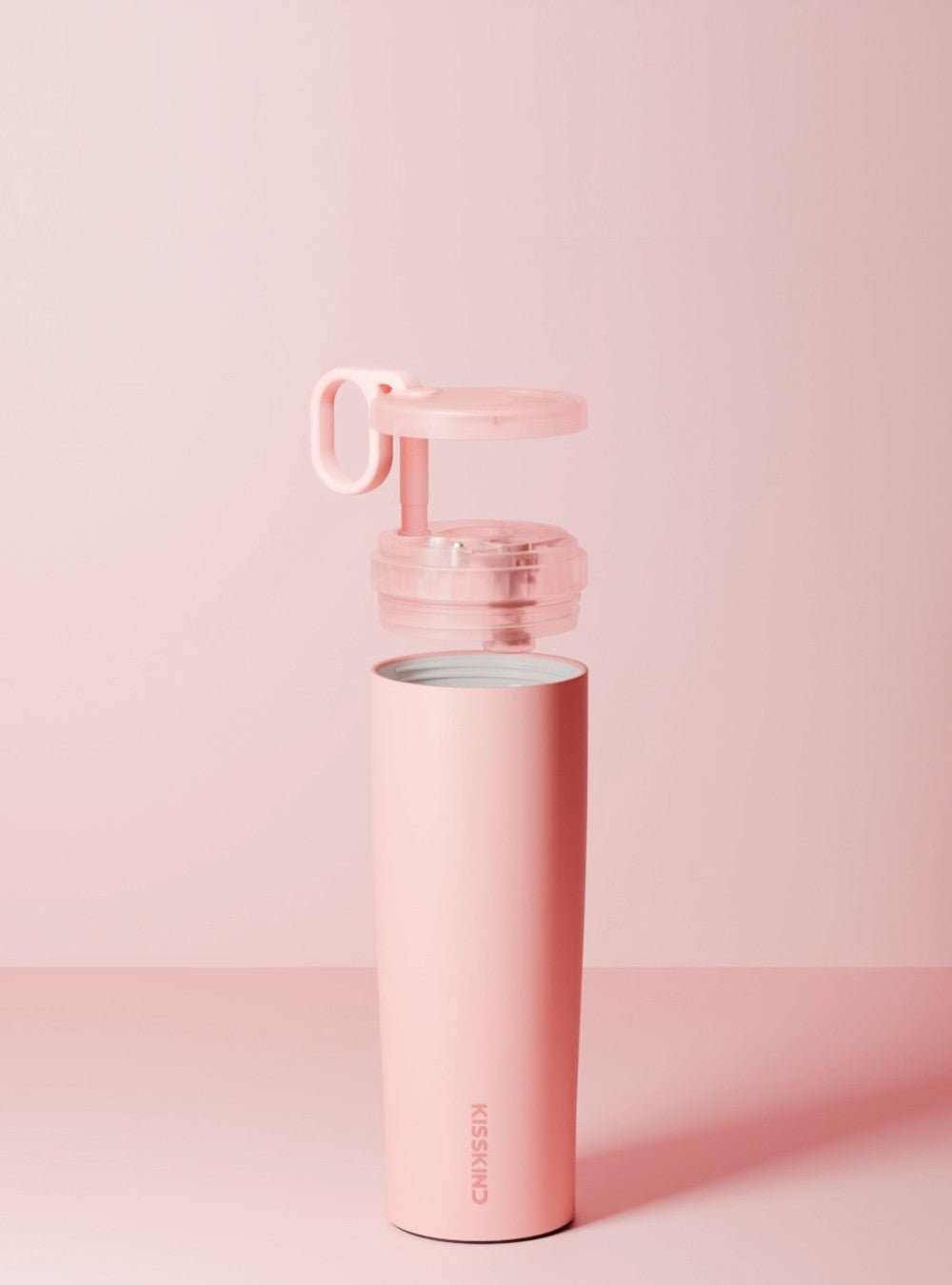 Lid, straw and ring lifted apart above the pink cup