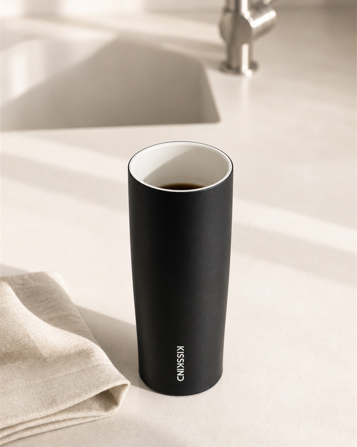 Open Kisskind tumbler showing its smooth white ceramic-coated interior