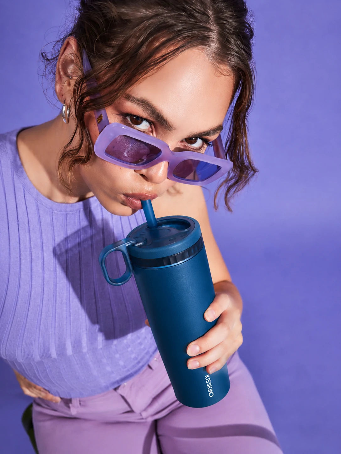 Kisskind tumbler being used with its soft silicone straw